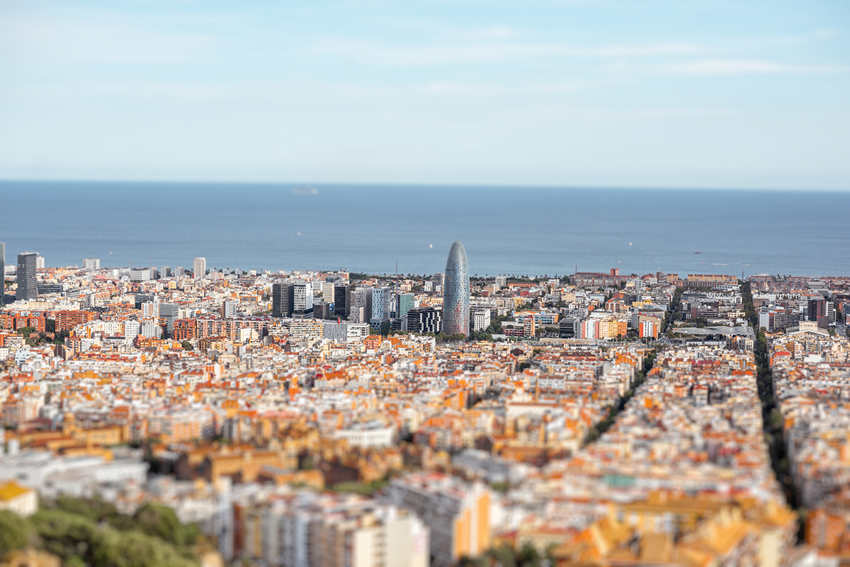 City view of Barcelona with the ocean in the distance.
