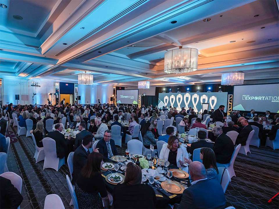 Audience sitting at dinner tables at awards ceremony